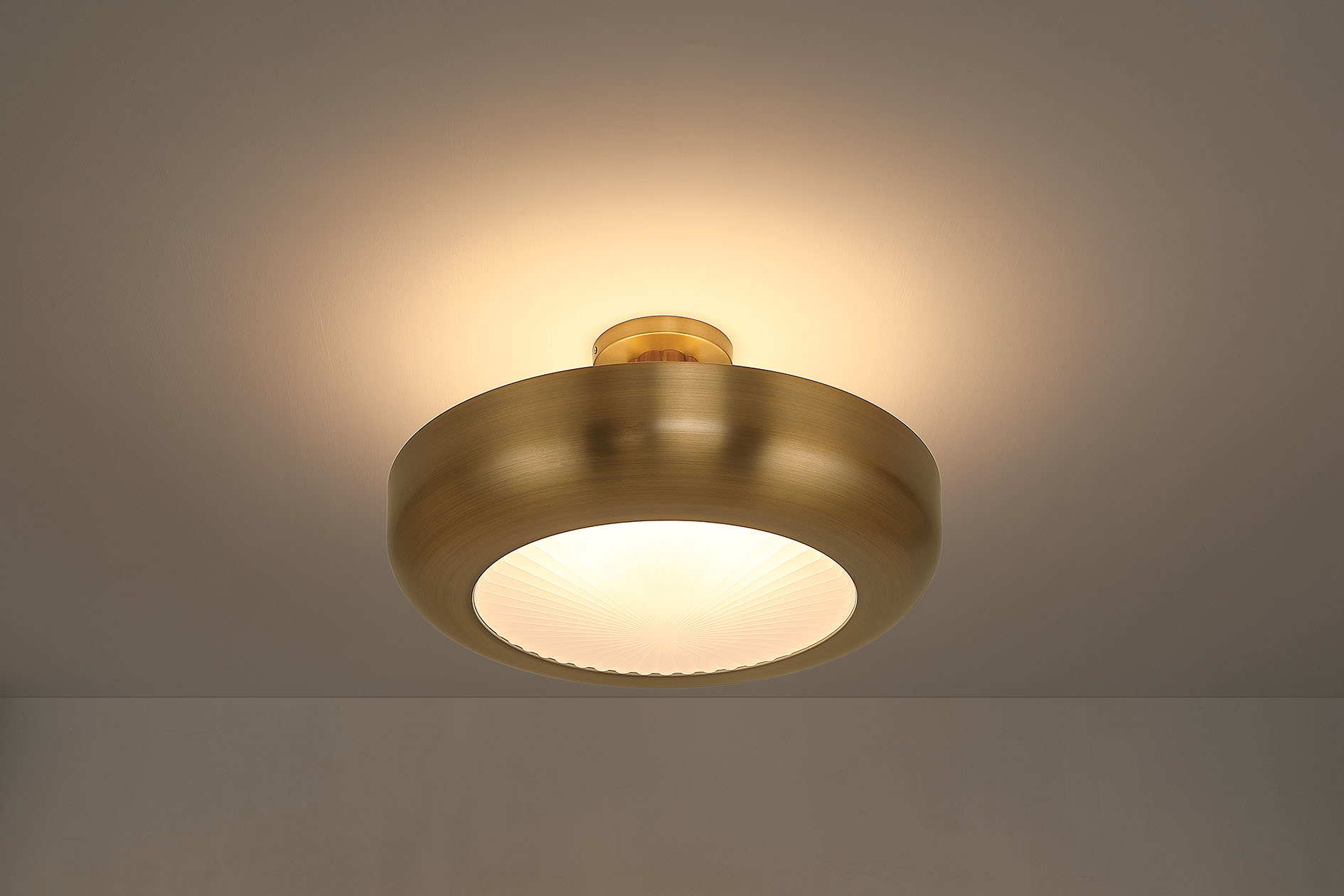 Macey Antique Brass semi-flush mount casting light upward and downward